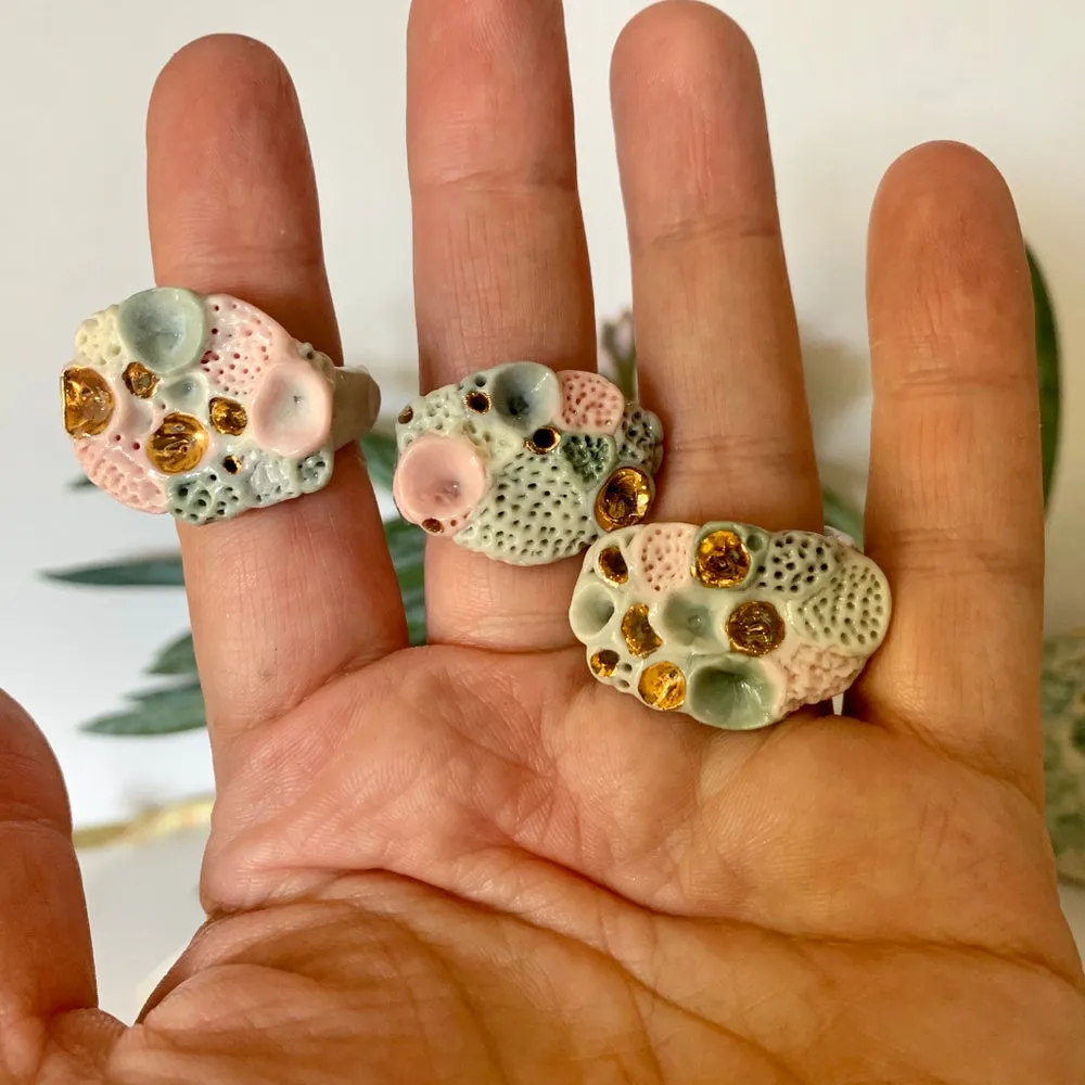 One green /pink/ grey with gold rock coral ring